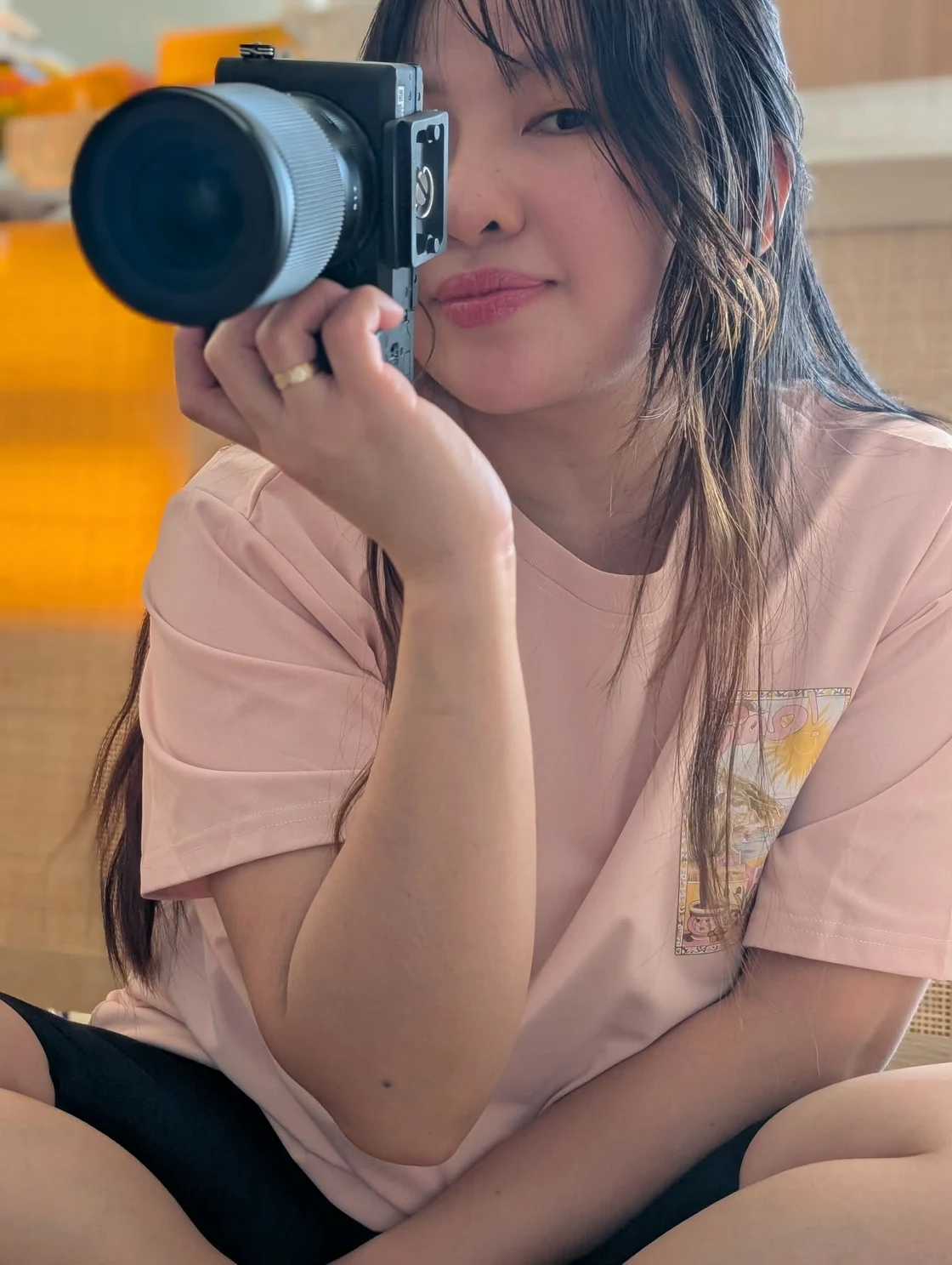 Mary Jane holding a camera while creating content