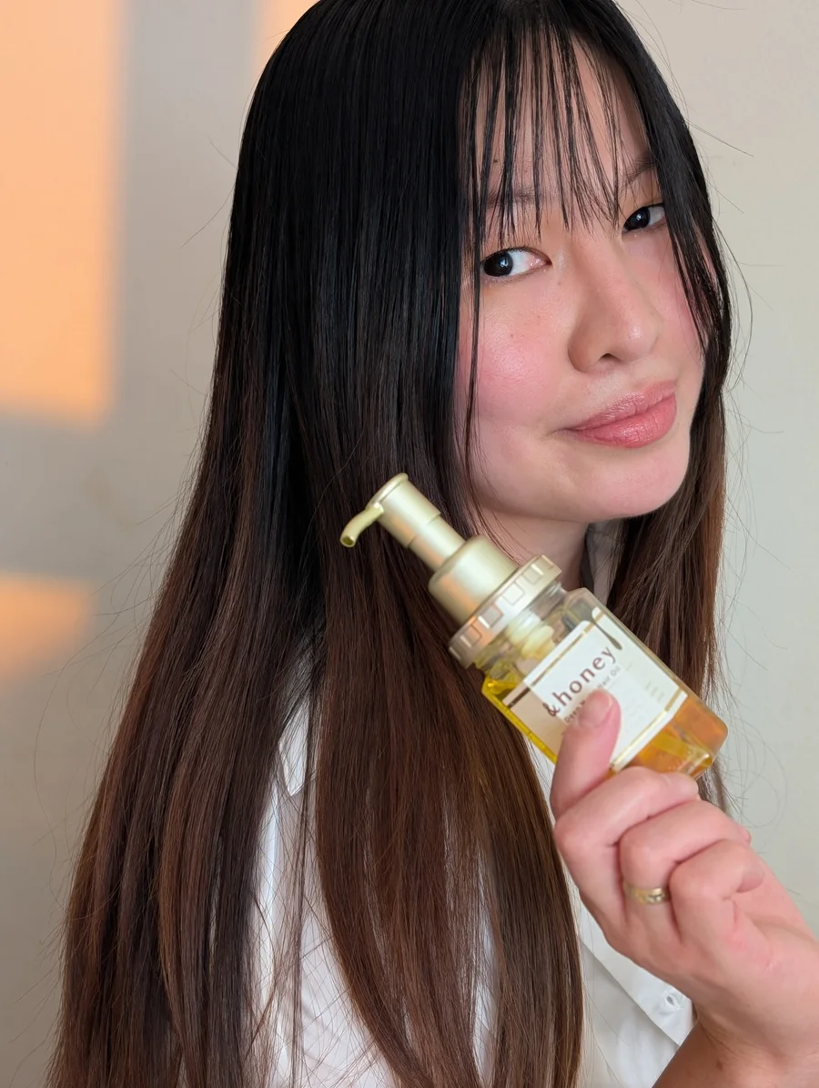Mary Jane holding a hair oil product