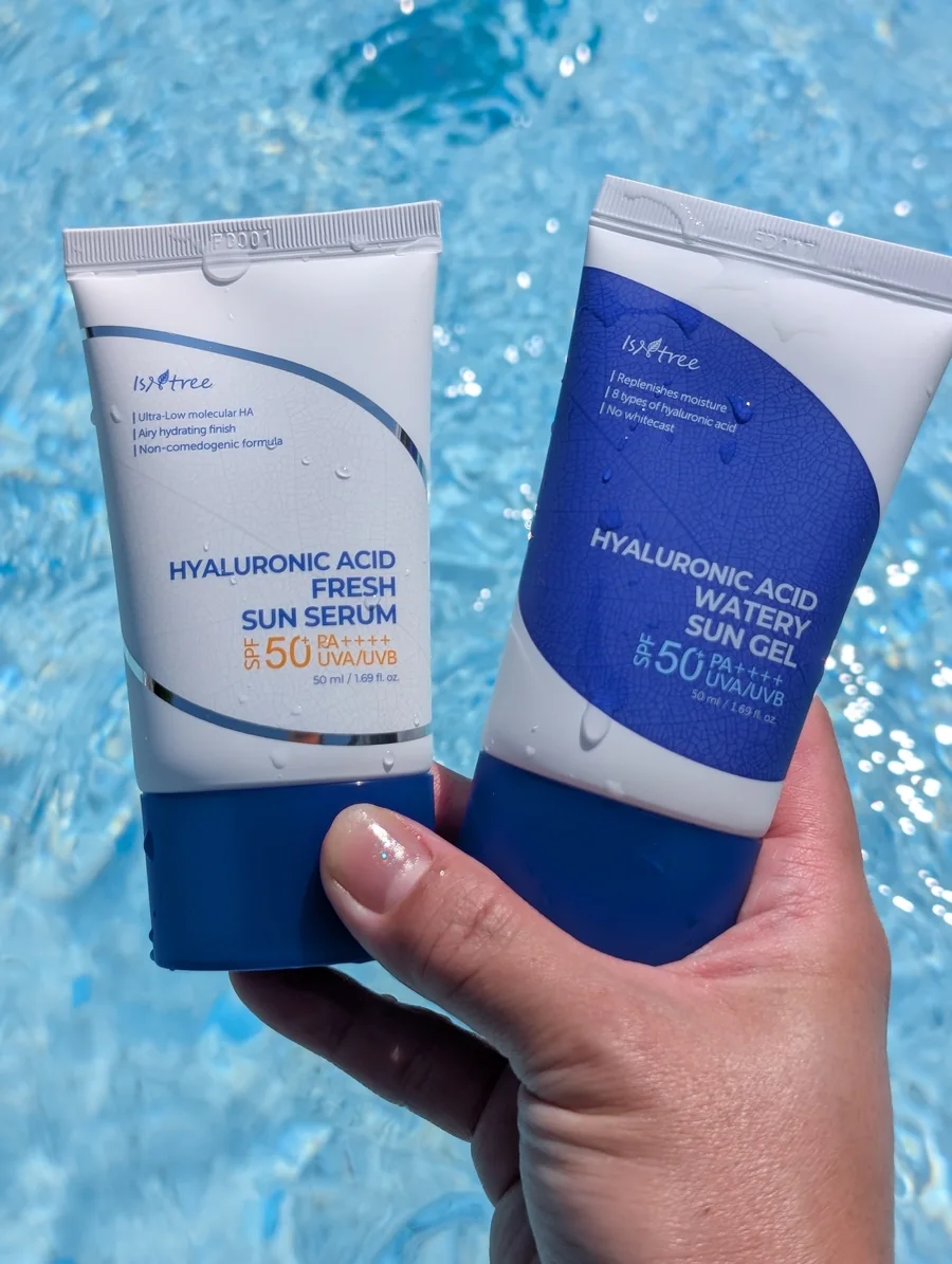 Two SPF products held over a swimming pool
